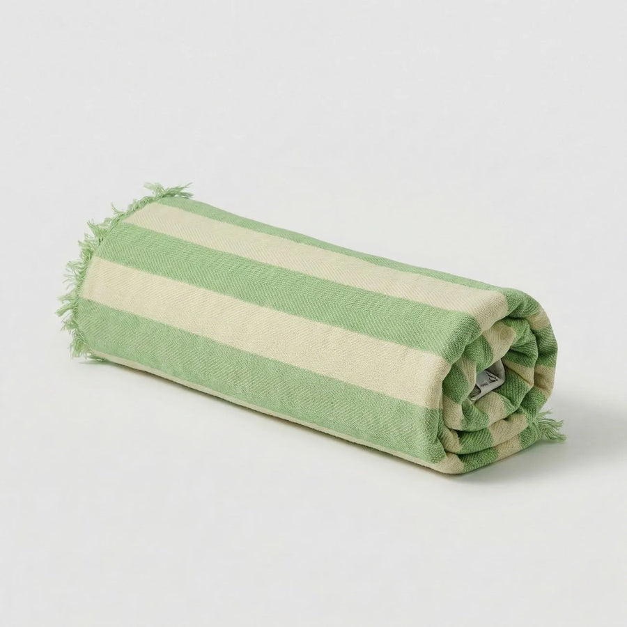 Rolled Bamboo Bath Towel with green and beige stripes, ideal for stylish bath routines.