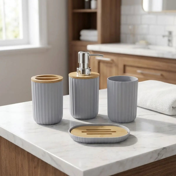 Stylish 4-piece bathroom accessory set on marble countertop, featuring soap dispenser, toothbrush holder, tumbler, and soap dish.
