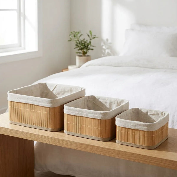 3-Piece Multi Size Bamboo Storage Basket Set on a wooden table, featuring natural bamboo slats and cloth lining.