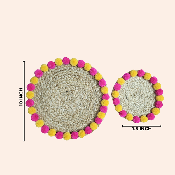 Diwali Duo Jute Weave Mat — two round jute mats with pink and yellow pompom trim, with 10 inch and 7.5 inch size labels.