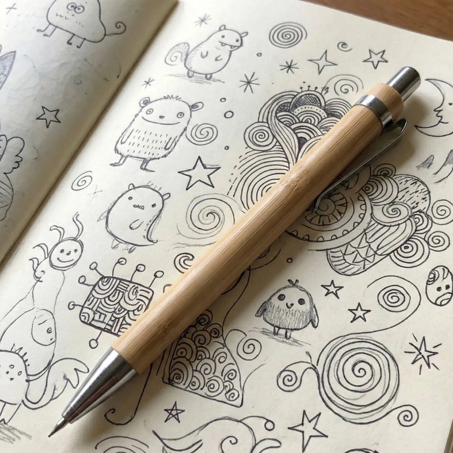 Bamboo Mechanical Pencil resting on a doodle-filled sketchbook, ideal for smooth writing and drawing.